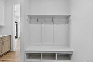 Mudroom with light wood-style floors
