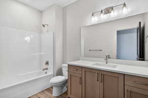 Full bath with vanity, shower / washtub combination, and light wood-type flooring