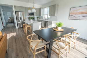 Dining space featuring dark wood-style floors and baseboards