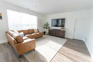 Living room featuring baseboards and light wood-style flooring