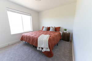 Bedroom with carpet and baseboards
