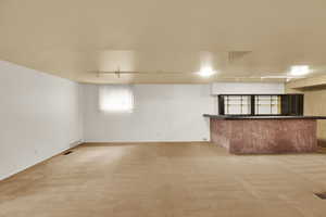 Interior space with rail lighting and light carpet