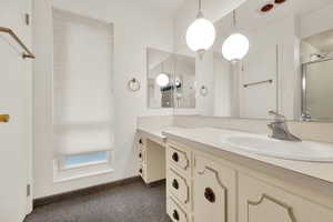 Bathroom with vanity and a stall shower