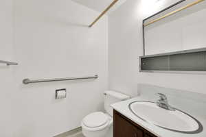 Half bath with vanity and toilet