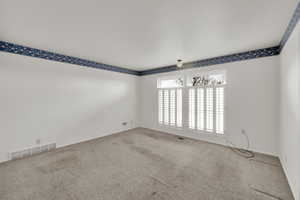 Unfurnished room with carpet
