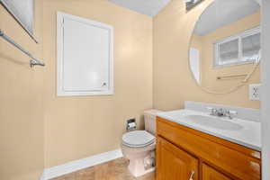 Half bath featuring vanity and toilet