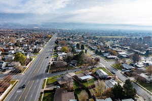 Aerial view of property and surrounding area with nearby suburban area