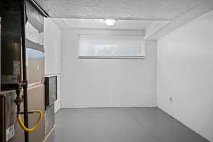 Utility room featuring heating unit