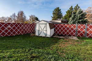 View of shed with a fenced backyard