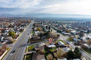 Aerial view of property and surrounding area with nearby suburban area