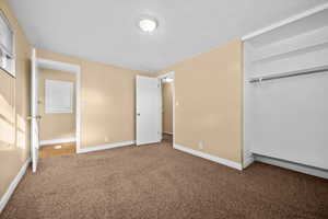 Unfurnished bedroom featuring carpet flooring and a closet