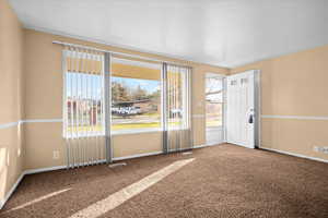 Carpeted spare room with baseboards