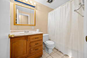Bathroom with a shower with curtain, vanity, and light tile patterned flooring