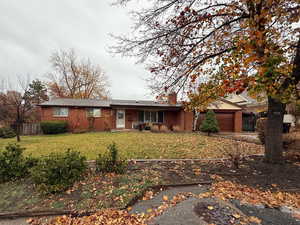 Ranch-style home featuring brick siding, concrete driveway, and an attached garage