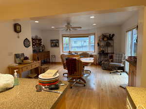 Dining space with light wood-type flooring, recessed lighting, and ceiling fan