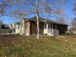 Rear and side view of home surrounded by large greenbelt area