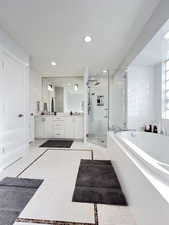 Primary full bathroom featuring double vanity, a bath, separate walk-in shower and tub
