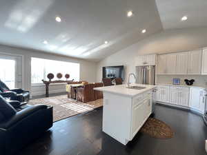 Beautifully remodeled and upgraded kitchen open to family room with vaulted ceilings and ample natural light