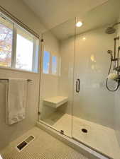 Full bathroom with a walk-in shower, tile walls and floor, and recessed lighting