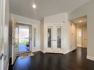 Entry to foyer featuring recessed lighting, dark wood flooring, vaulted ceiling, and French Doors leading to office/den
