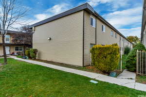 View of property exterior with a lawn