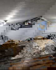 Living room with a textured ceiling and wood finished floors