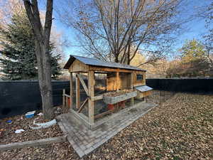 View of poultry coop with a fenced backyard
