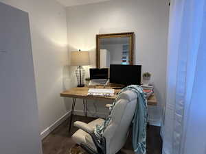 Home office featuring dark wood-style floors