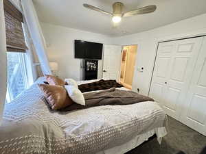 Bedroom featuring carpet, ceiling fan, and a closet