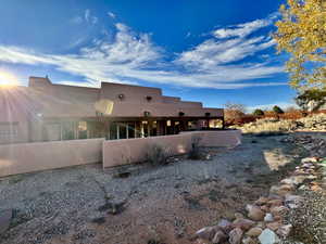 Rear view of house featuring stucco siding
