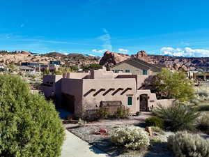 View of front of house with stucco siding and a mountain view
