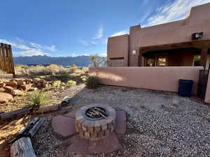 View of patio with an outdoor fire pit and a mountain view