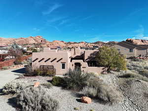 Pueblo revival-style home with a mountain view and stucco siding