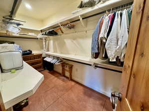 Walk in closet with light tile patterned flooring