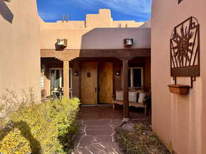 Doorway to property with stucco siding