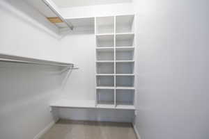 Walk in closet with light carpet