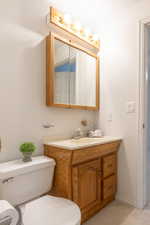 Half bath with vanity and light carpet