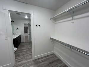 Second view of the spacious walk-in closet showing additional shelving and organization space.