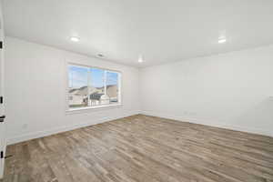 Huge upstairs loft with large windows and plenty of open floor space — ideal for a second living room, playroom, or home office.