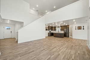 Large open-concept living space that seamlessly connects to the kitchen and entryway. Perfect for entertaining with plenty of room to gather.