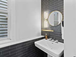 Bathroom featuring tile walls and decorative backsplash