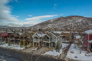 Snowy aerial view featuring a residential view and a mountain view
