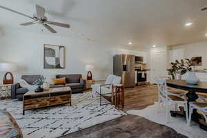 Living room featuring wood finished floors, recessed lighting, and a ceiling fan