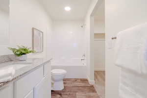 Full bathroom featuring vanity, bathing tub / shower combination, and light carpet