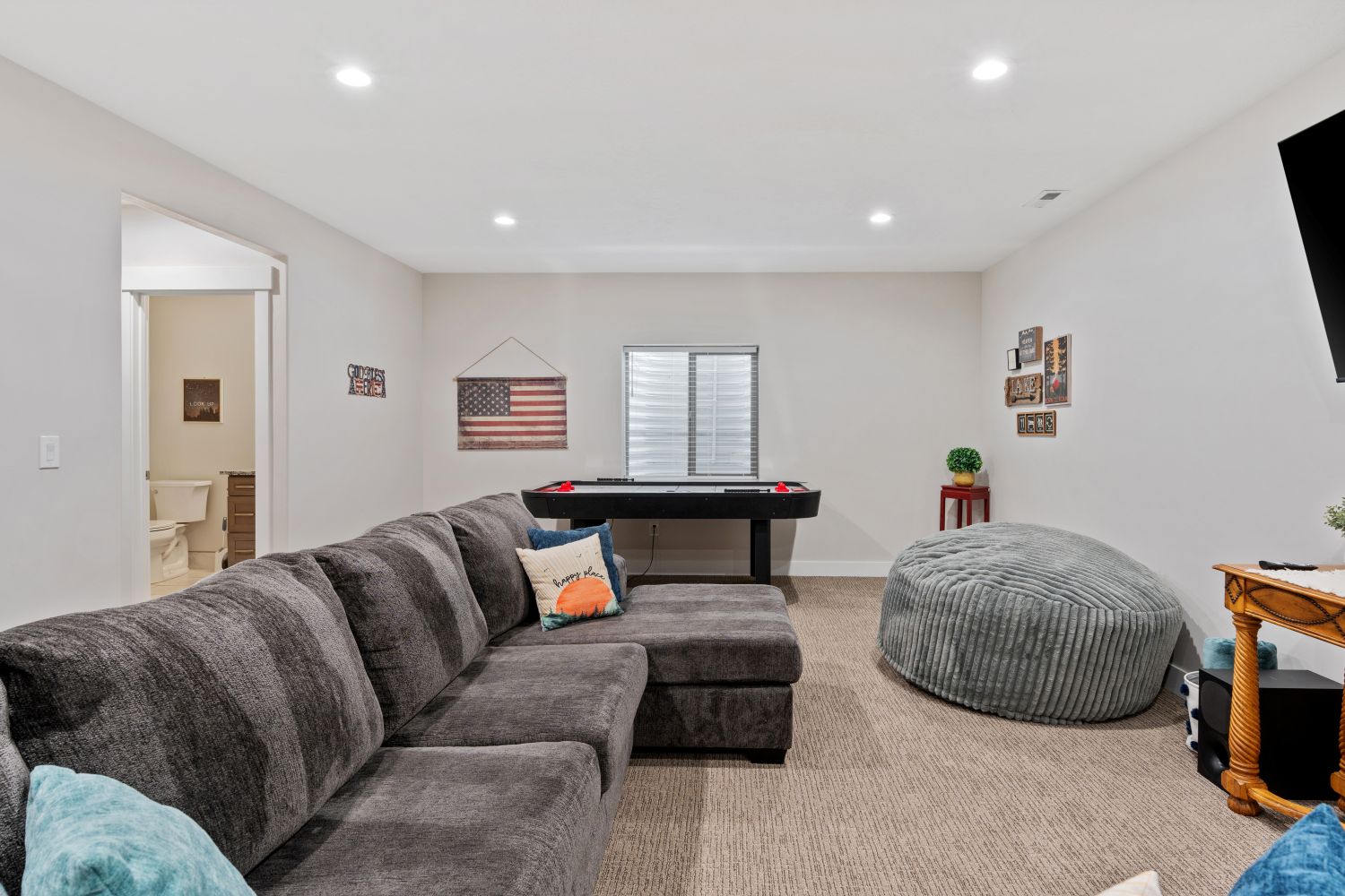 Living room featuring light colored carpet and recessed lighting
