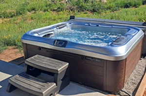 View of patio / terrace with a hot tub