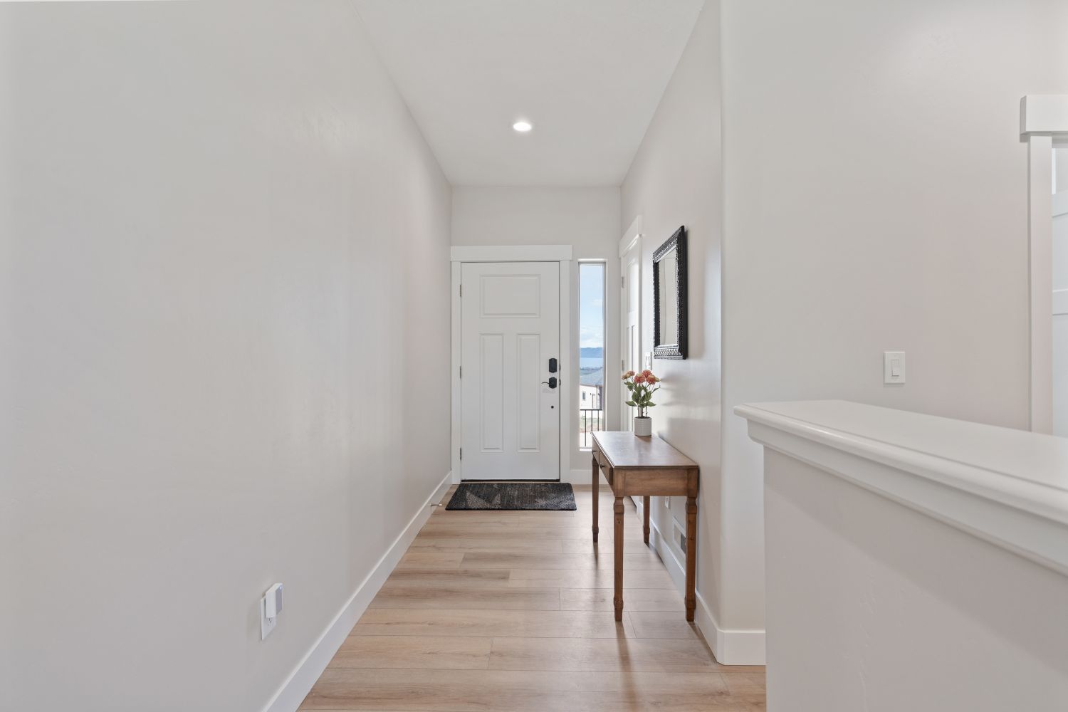 Foyer entrance featuring light wood finished floors and recessed lighting