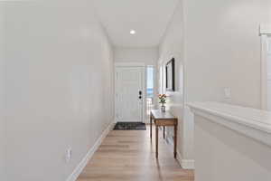 Foyer entrance featuring light wood finished floors and recessed lighting