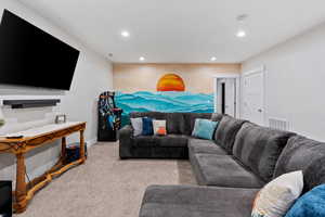 Living area featuring recessed lighting and light carpet