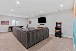 Living room with light carpet and recessed lighting